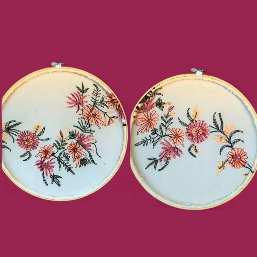 Set of two matching floral embroidered bamboo hoop art. 12” and 10.5”.